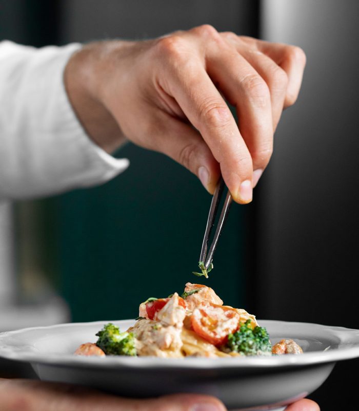 side-view-hand-holding-plate-with-food
